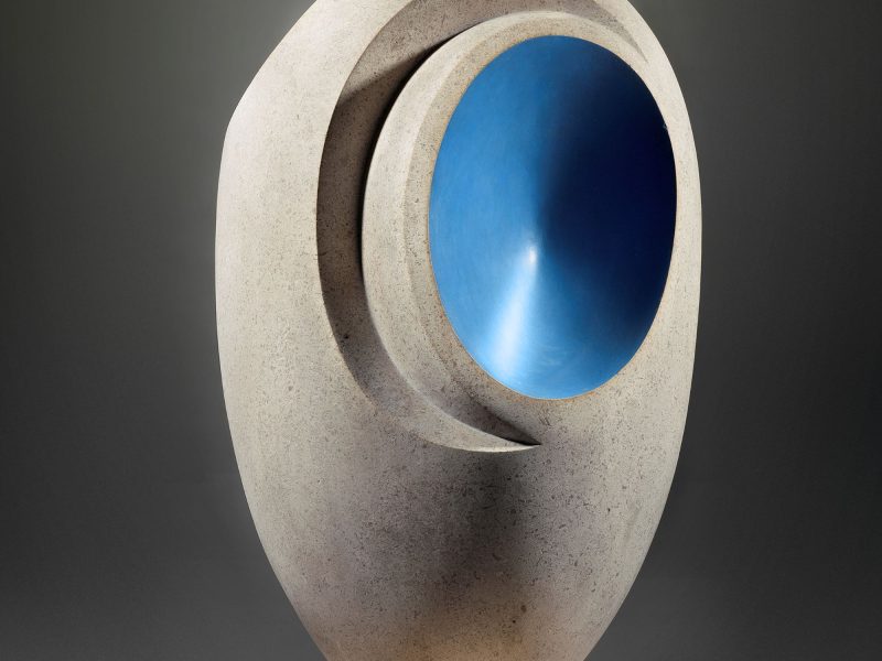 Sculpture by Barbara Hepworth featuring a smooth stone form with a vibrant blue interior section.