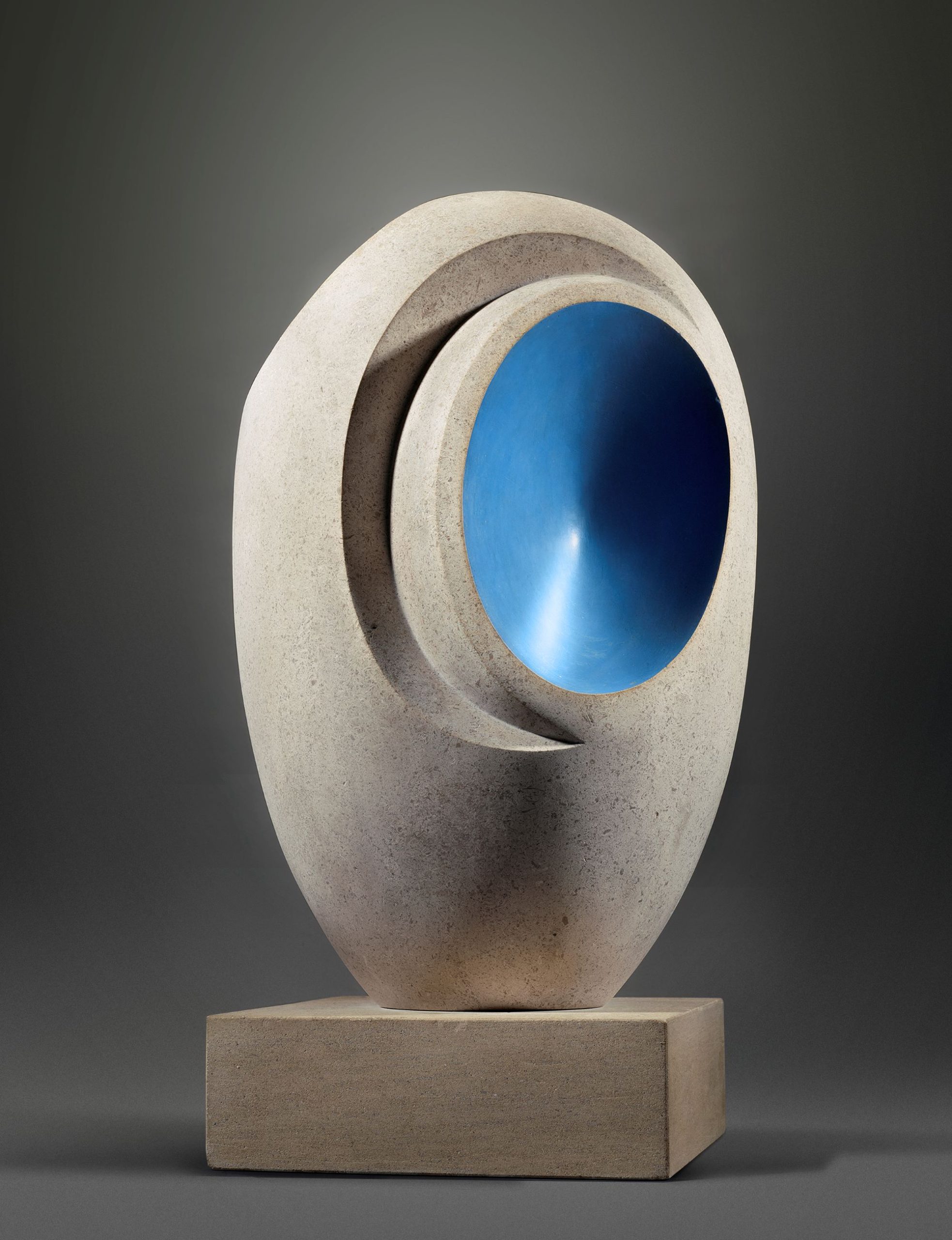 Sculpture by Barbara Hepworth featuring a smooth stone form with a vibrant blue interior section.
