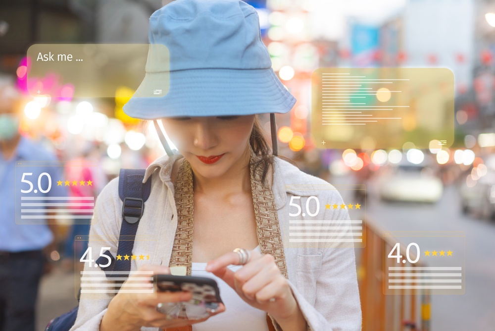 A woman with a blue hat checks her phone in a bustling street, with star ratings and prompts displayed around her.