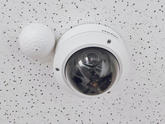 a white CCTV on a wall