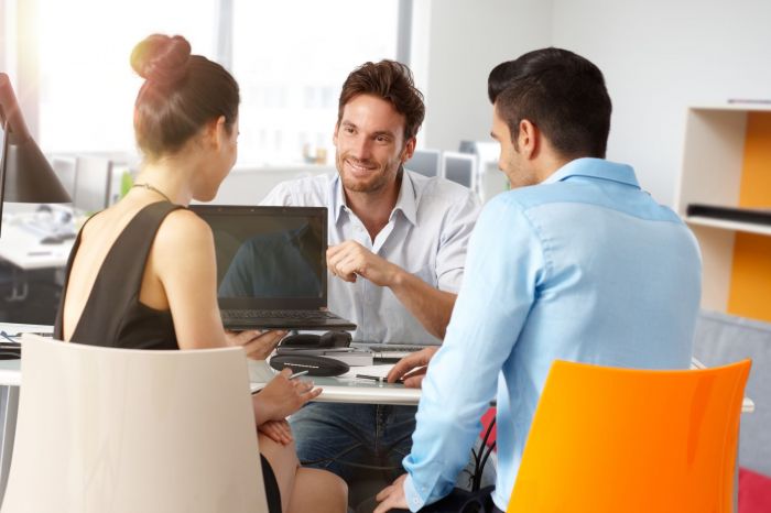 Several people seated at a table, actively participatin