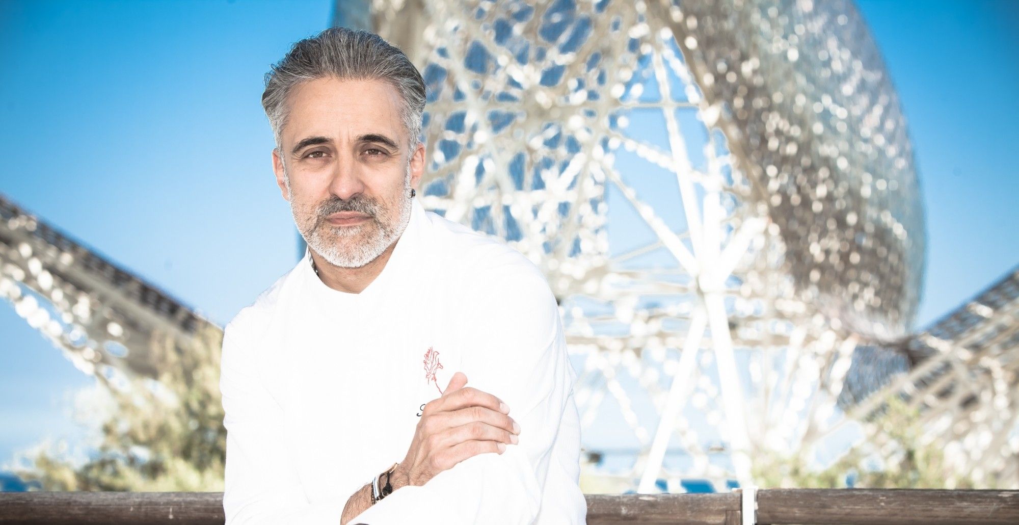 Sergi Arola poses In chef whites outside of Hotel Arts Barcelon